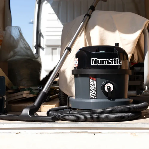 Numatic TRM240H dust extraction vacuum stored in work van with cleaning hose and floor tool
