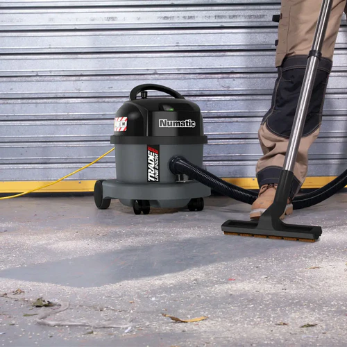 Numatic TRM240H dust extractor cleaning construction dust on workshop floor