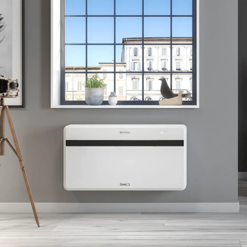 Olimpia Splendid Unico EVO-F monobloc heat pump air conditioner installed beneath window in modern interior