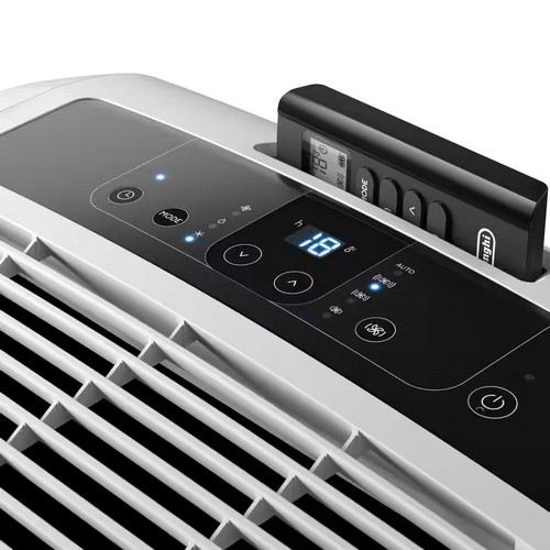 Close-up of the black soft-touch digital control panel on top of the De'Longhi Pinguino PAC EM82K.1, showing an active blue LED temperature display of 18 degrees Celsius and the remote control docked in its storage slot.